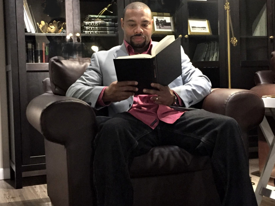 Pastor Eugene Taylor reading a book