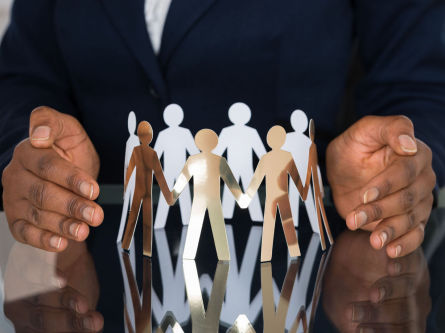 Man with hands around cut out people